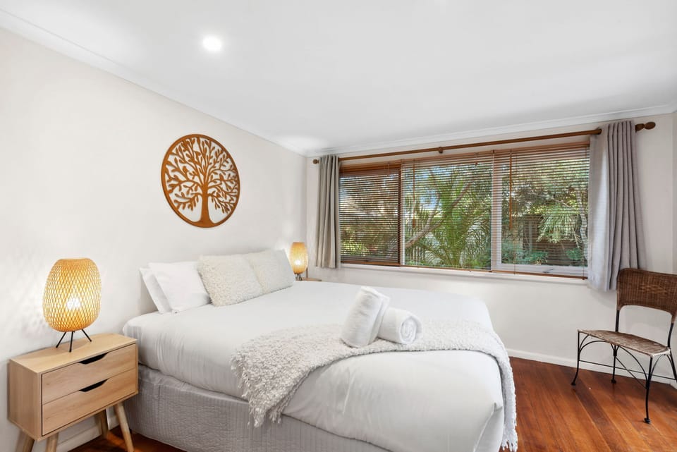 The master bedroom features a Queen bed, an ensuite bathroom, and direct access to the west deck