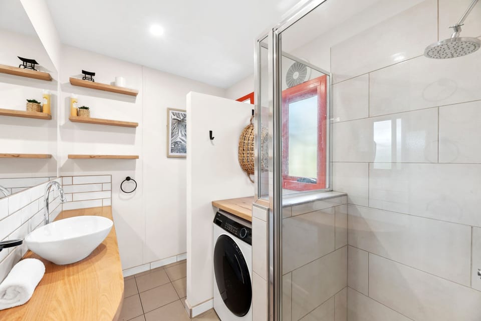 Bathroom with combined laundry facilities