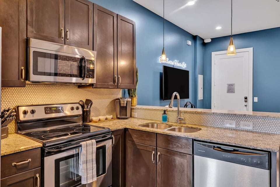 The adjacent kitchen continues the industrial-modern theme, seamlessly integrating into the living area.