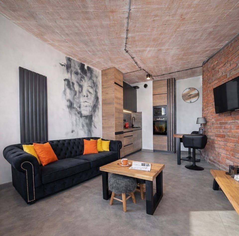 Charming urban lounge with smart TV, bold textures, and industrial décor that feels like home.
