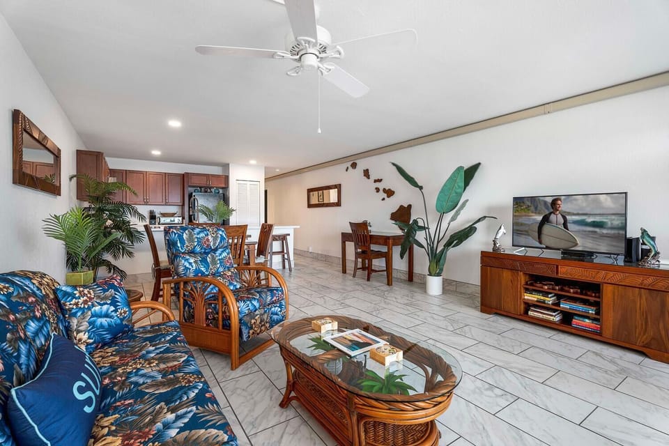 Bright, open living area with ceiling fans and a clean, coastal design.