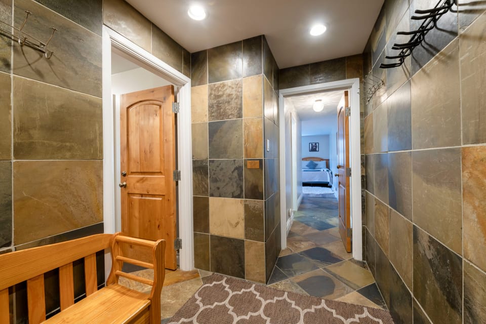 Entry with boot bench, coat hooks, shelving for goggles/helmets, ski racks