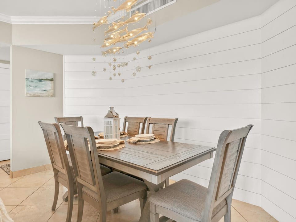 Your elegant dining space features warm wood tones and twinkling lights, creating the perfect atmosphere for memorable meals together.