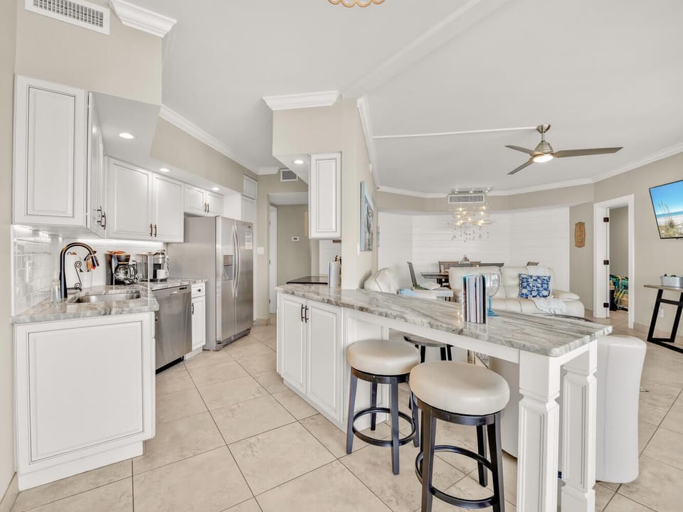 Your spacious open kitchen features granite countertops, stainless steel appliances, and a breakfast bar perfect for morning coffee or casual meals.