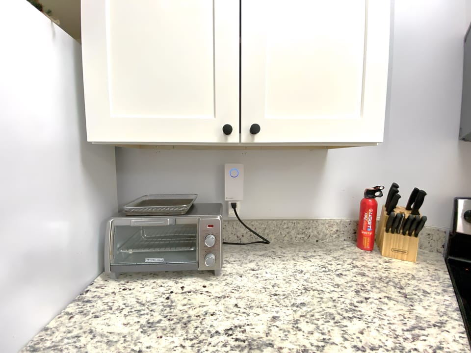 Modern and sunny kitchen with granite countertops, stainless steel appliances.