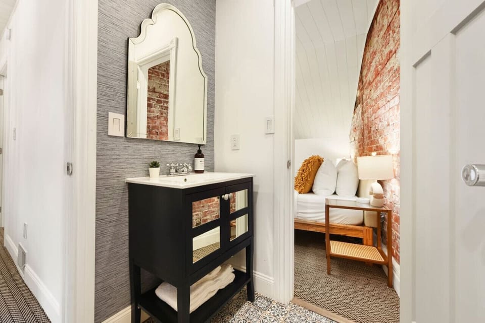 Stylish vanity with modern finishes and easy access to the bedroom