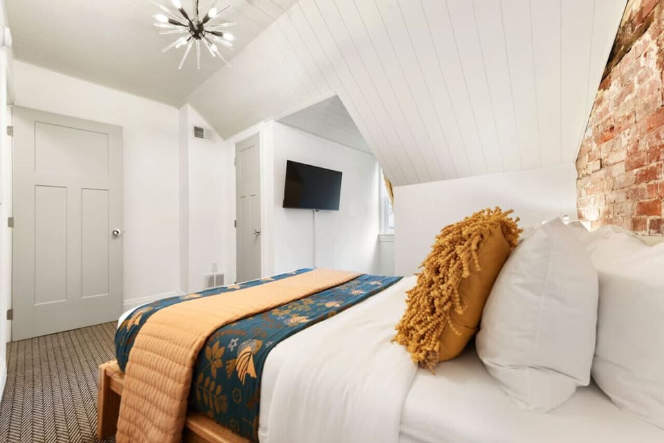 Bright, cozy bedroom with luxe linens and smart TV for easy unwinding