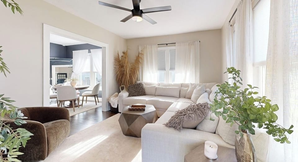  Living room is spacious with a large sectional.  Large doorway, open floor plan