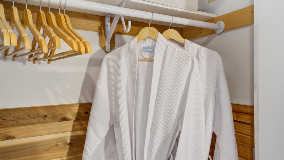 Enjoy the convenience of a well-organized closet complete with plush robes, adding a touch of luxury to your stay.