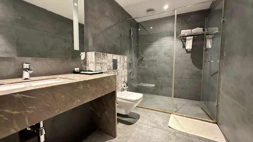 Executive Room | Bathroom | Shower, hair dryer, slippers, towels