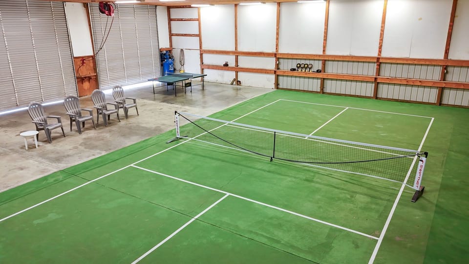 Enjoy friendly competition in our 6k sqft outbuilding w/ full pickleball court!