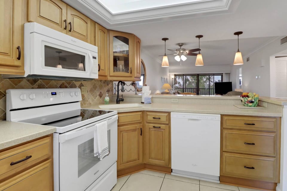 The open kitchen has abundant cabinets, full-size appliances and is well stocked with cookware, dinnerware and many kitchen tools and gadgets.