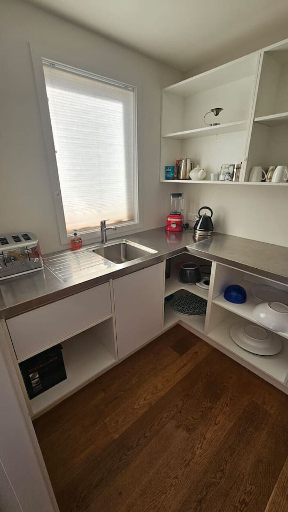 Skullery off the kitchen, with lots of appliances and space for food items.