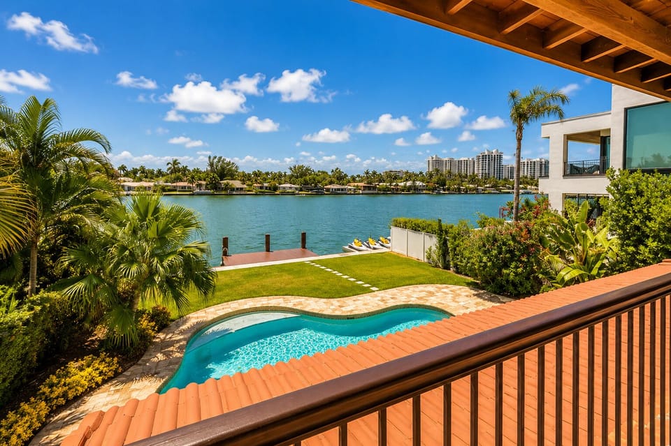 Private waterfront pool, tropical lawn, and serene bay views