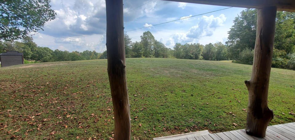Peaceful porch view overlooking spacious, open green lawn