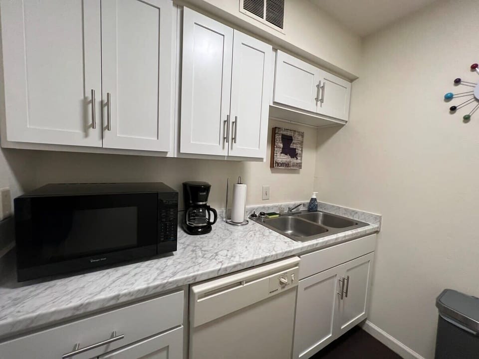 Recently remodeled kitchen includes dishwasher, microwave, coffeemaker and coffee, toaster