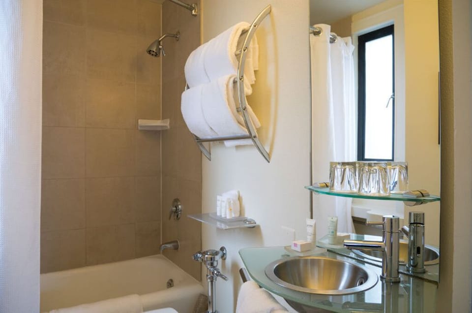 Spacious and modern bathroom in our premium room, featuring high-end fixtures and a bright, clean design.