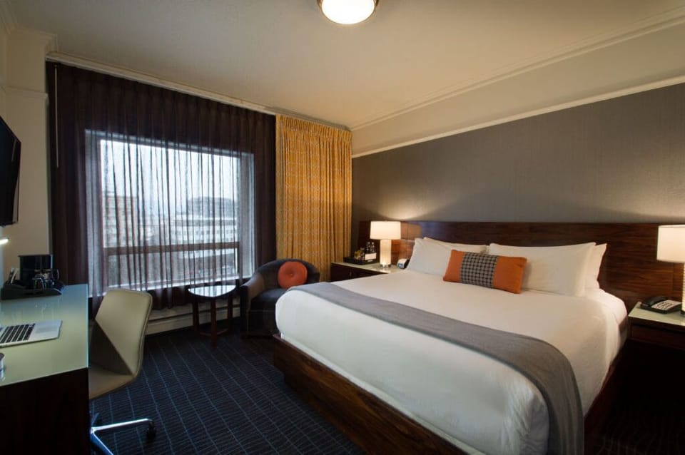 A serene retreat: Premium room with queen bed, featuring soft lighting and a relaxing atmosphere.