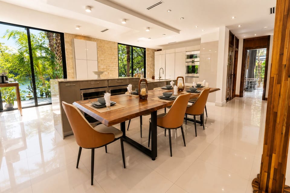 Bright modern kitchen-dining space with tropical views and stylish seating