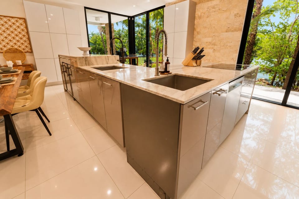 Bright luxury kitchen with marble island and tropical garden views