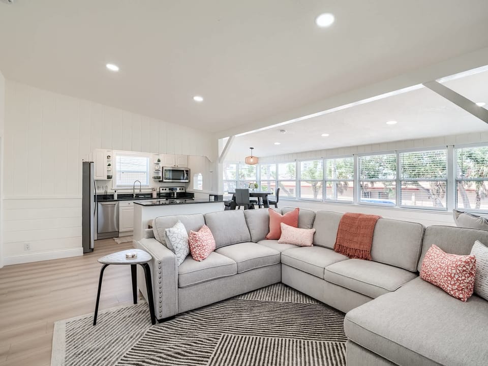 Living Room: Sink into the sectional sofa perfect for relaxation and entertaining after beach adventures!