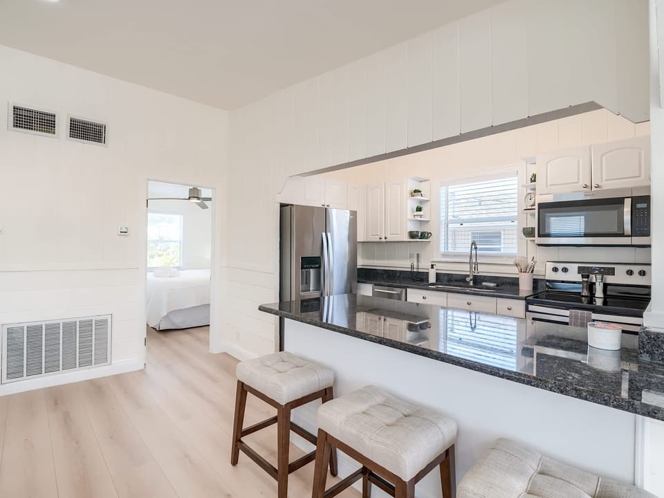 Kitchen Delight: Bright space with sleek appliances and bar seating for culinary adventures!