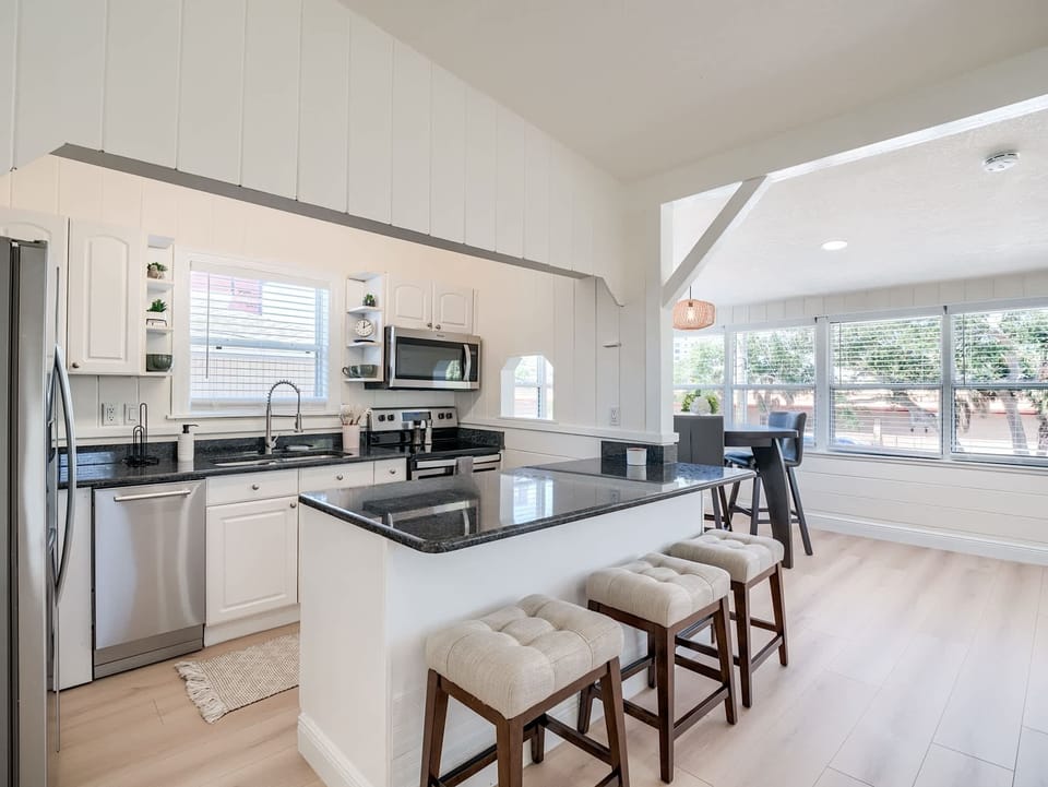 Kitchen: Bright and airy with sleek granite counters and inviting seating for delightful meals!