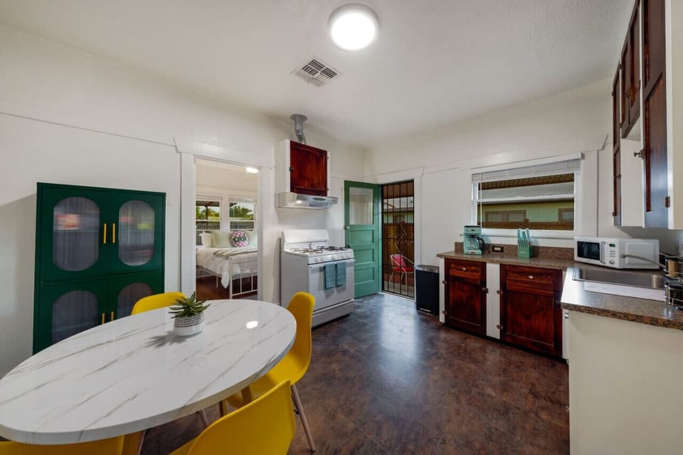 View of the eat-in kitchen, entrance to bedroom, and access to covered patio