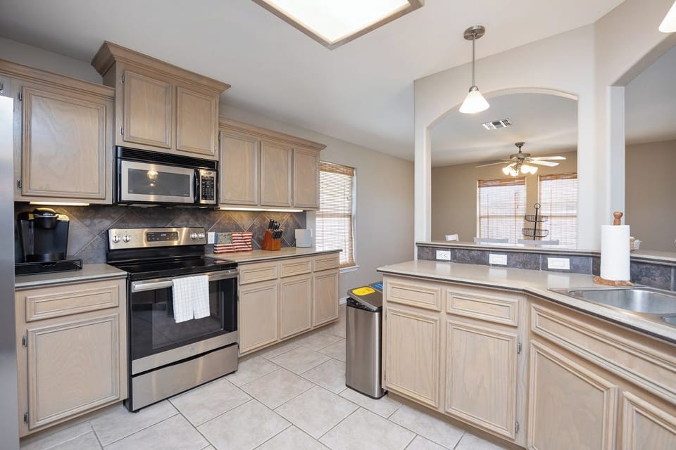 Your spacious kitchen features granite countertops, stainless steel appliances, and ample cabinet storage for all your culinary adventures.