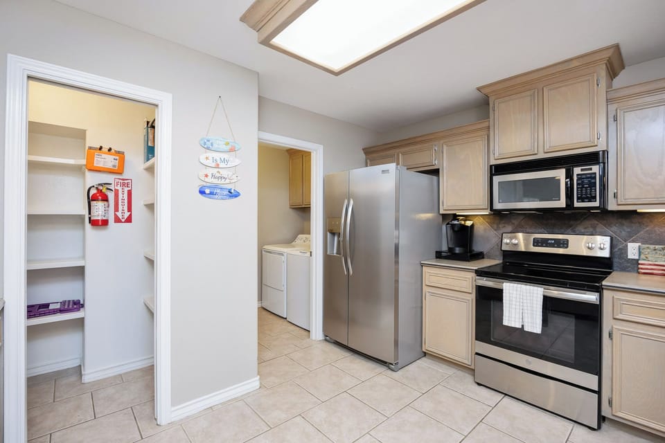 Your fully equipped kitchen features stainless steel appliances and a bright skylight that fills the space with natural light while you cook.