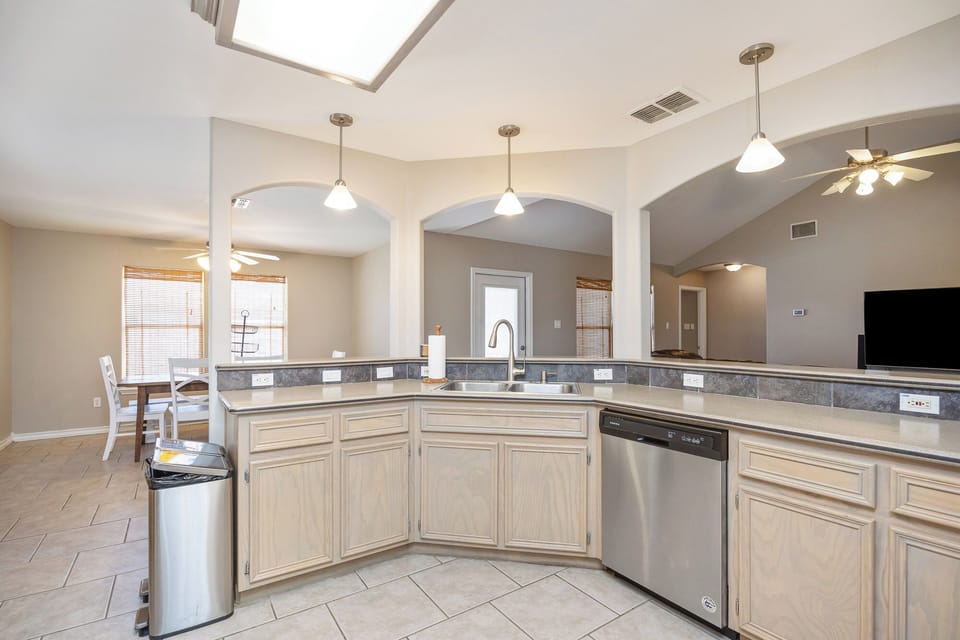 Your spacious kitchen features granite countertops, stainless appliances, and pendant lighting—perfect for preparing memorable vacation meals together.
