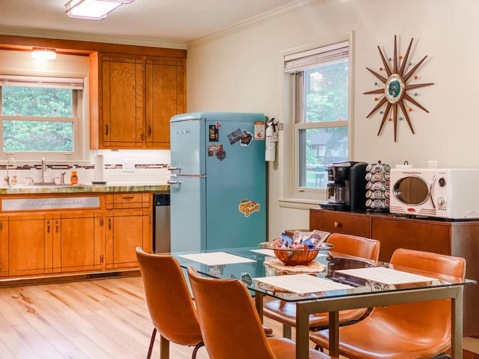 The restored retro kitchen is fully stocked for easy meals, coffee before the trails, or a cozy night in at your stylish Rogers vacation rental.