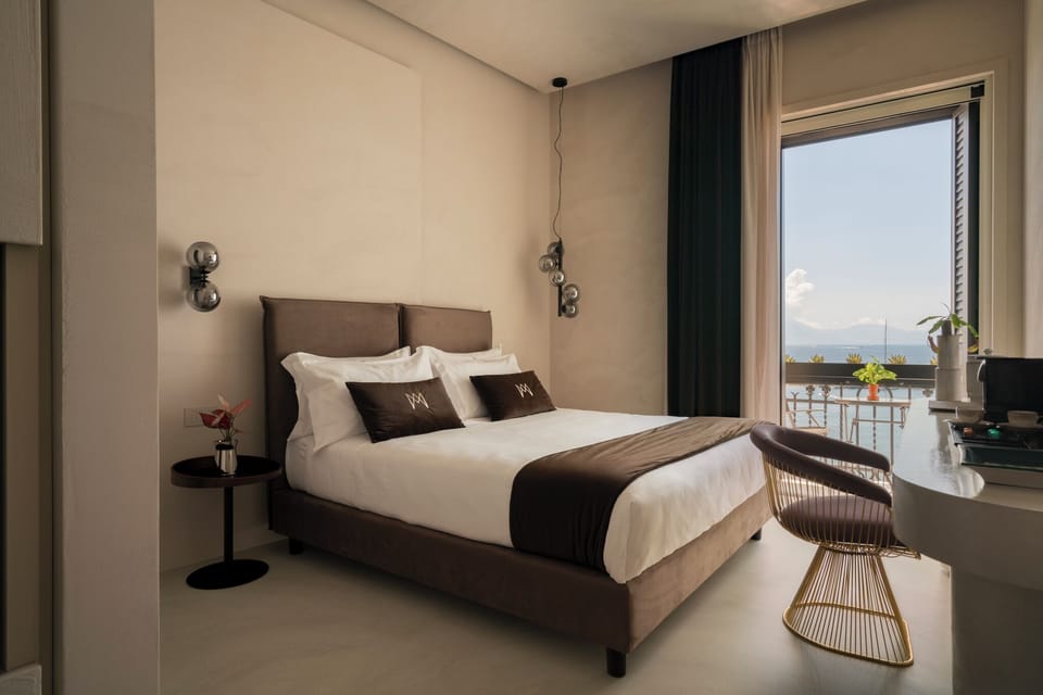 Deluxe Room, Balcony, Sea View | Minibar, in-room safe, desk, soundproofing