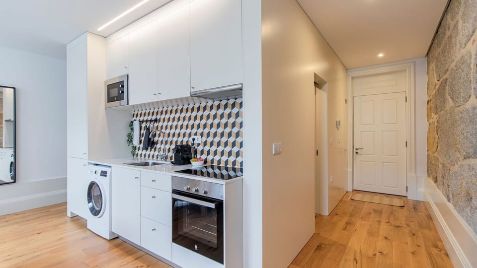 Modern kitchenette, equipped with all the utilities and essentials you might need during your stay, like a microwave, stove and oven, washing machine and more! #practical #nice