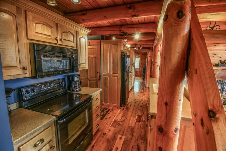 Chop, stir, and savor in this charming log-cabin kitchen, with a breakfast bar - perfect for morning pancakes or evening beverages.