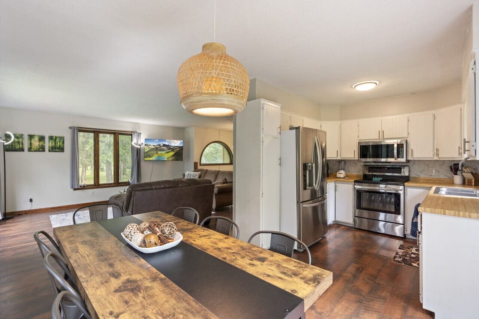 Open concept main floor kitchen with dining and living.