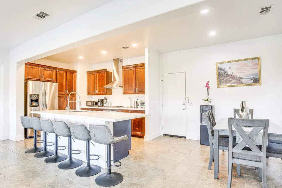 Open kitchen with dining area and bar stool
