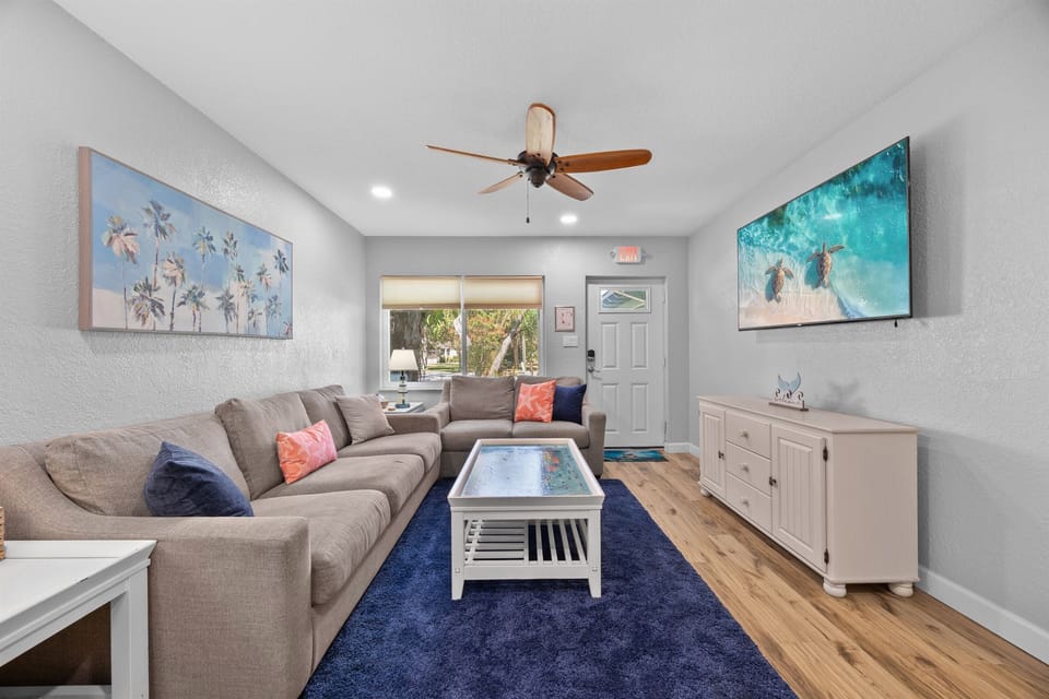 Living Room: Bright and airy retreat featuring beachy decor, comfy seating, and fun vibes!