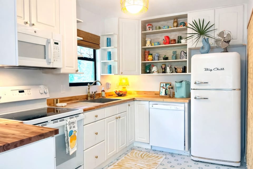 The kitchen is a delightful blend of cozy cottage charm and vibrant tiki flair.