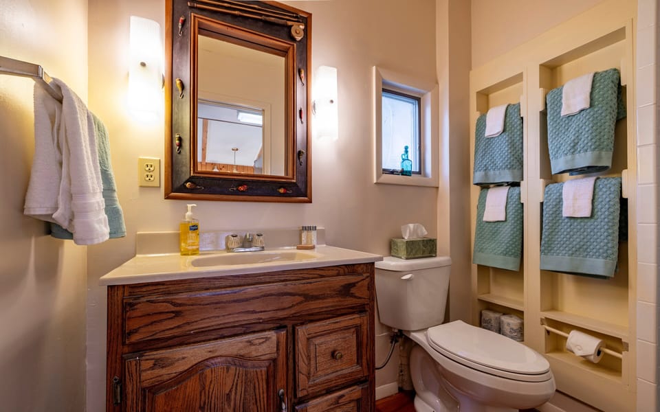 The bathroom features a step in shower