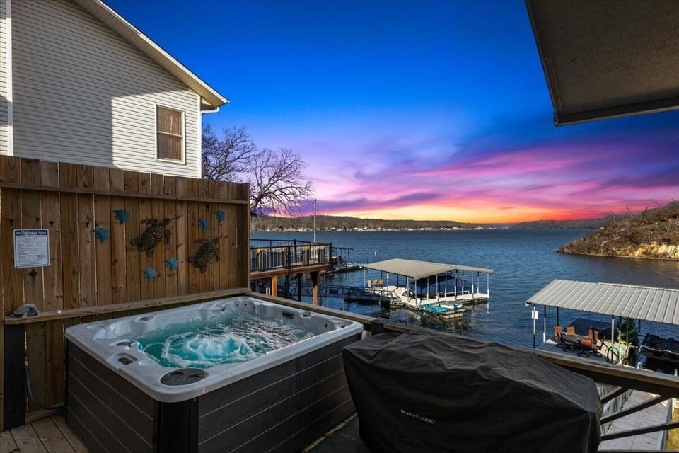 Enjoy amazing sunrises and sunsets from the private hot tub on the deck overlooking the lake at Seawall Family Retreat!