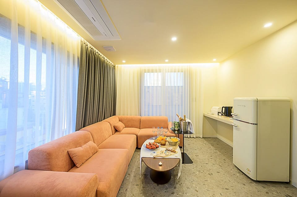 Signature Room | Living area | 75-inch Smart TV with digital channels, heated floors