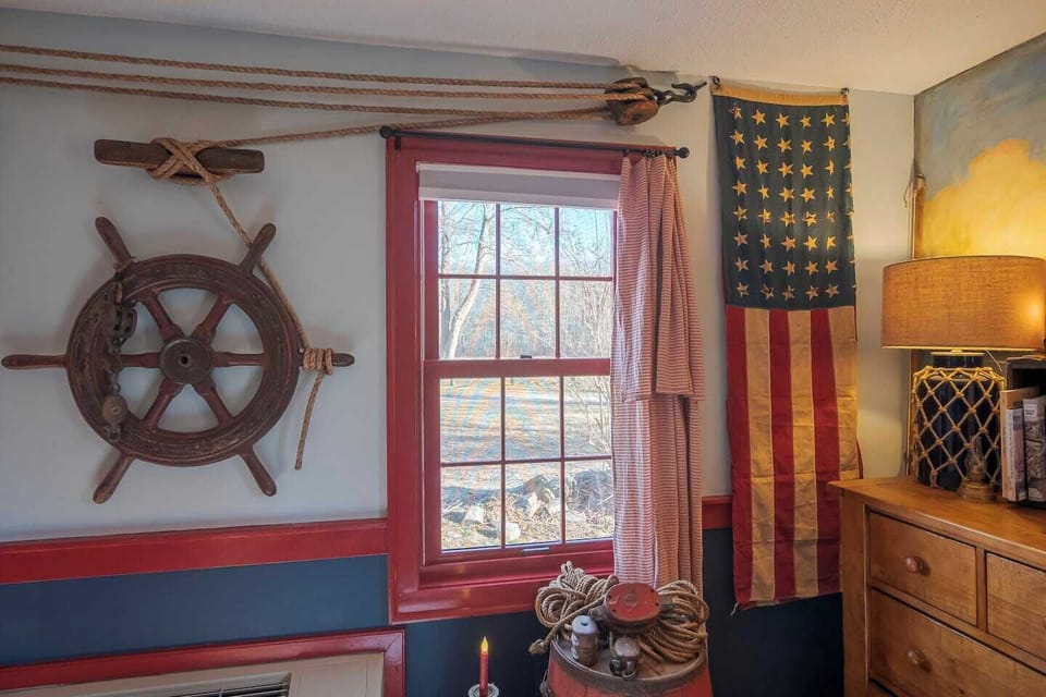 Oh, the voyages that ship's wheel has seen! A great view of the field behind the Carriage House. 