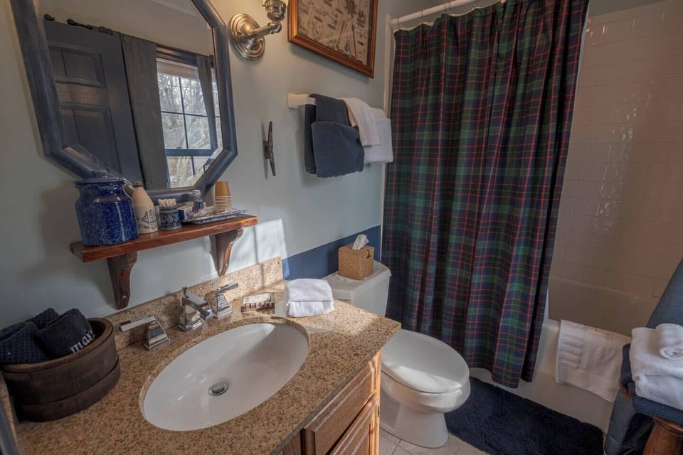 A cozy bathroom- the tub is a single whirlpool tub for much-needed private time to yourself.