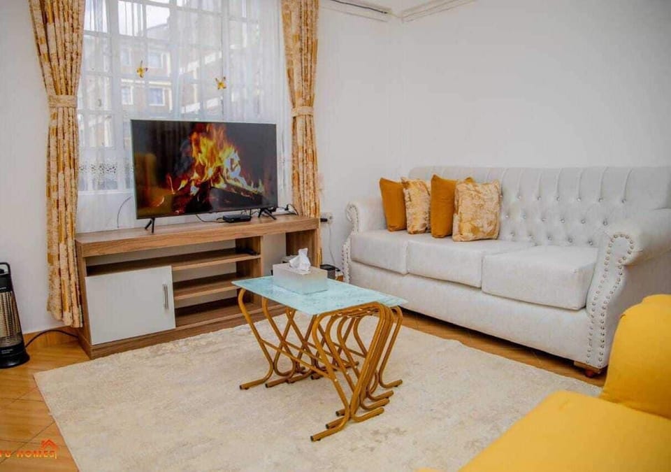 Comfort Apartment, City View | Living area | 24-inch Smart TV with digital channels