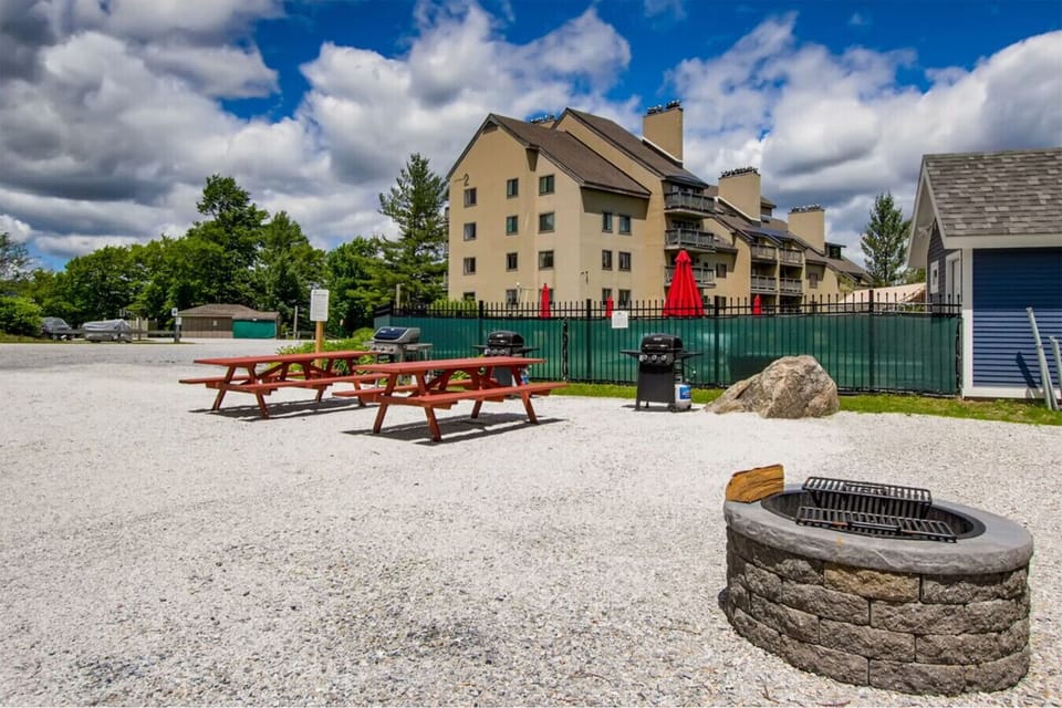 Shared outdoor table and bench for communal enjoyment.