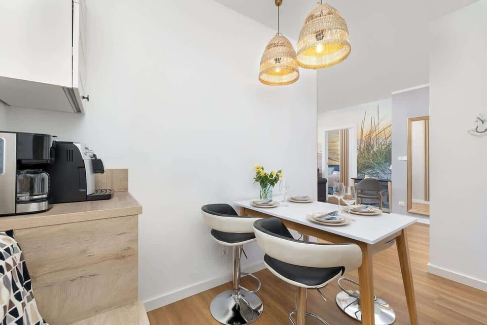 The sleek design of the kitchenette blending seamlessly with the living area.