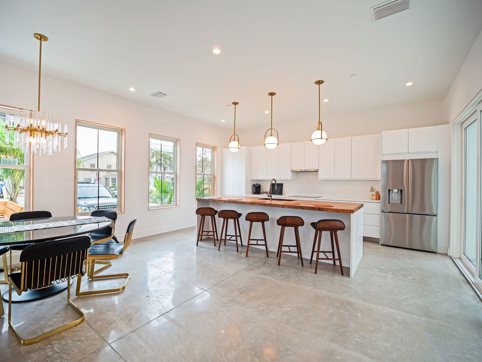 Open-concept kitchen and dining area with abundant natural light and seamless flow for gathering and entertaining