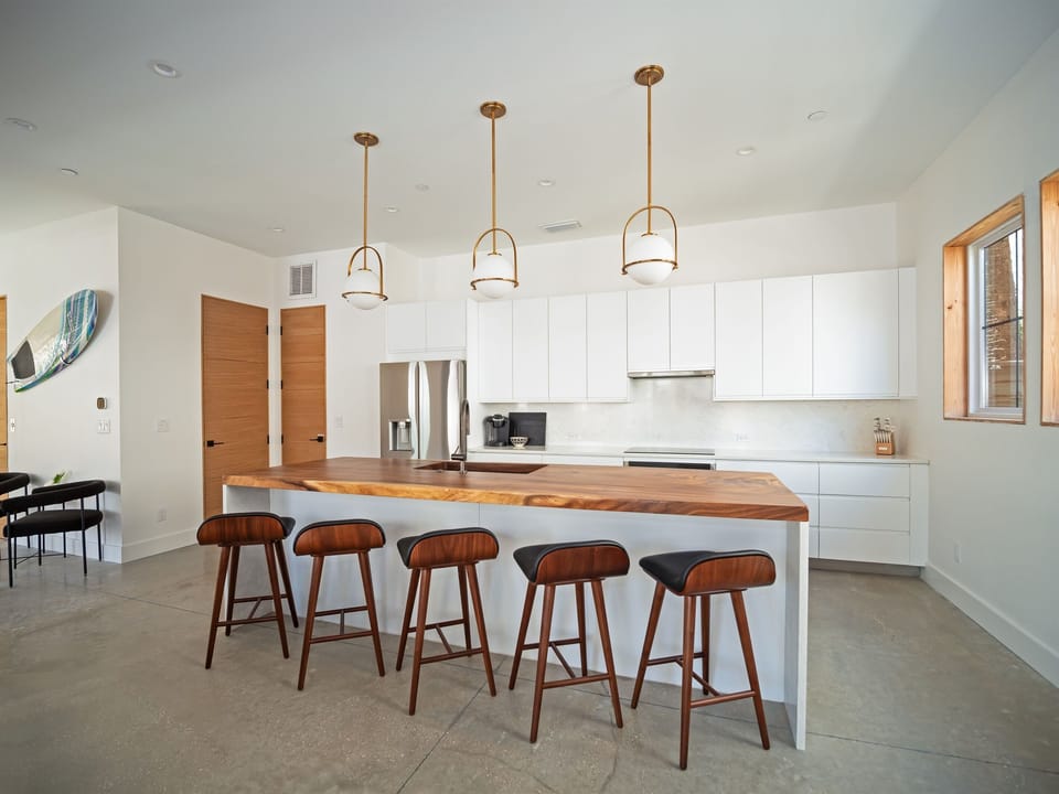 A light-filled kitchen with clean lines, warm wood tones, and a spacious island designed for both cooking and connection