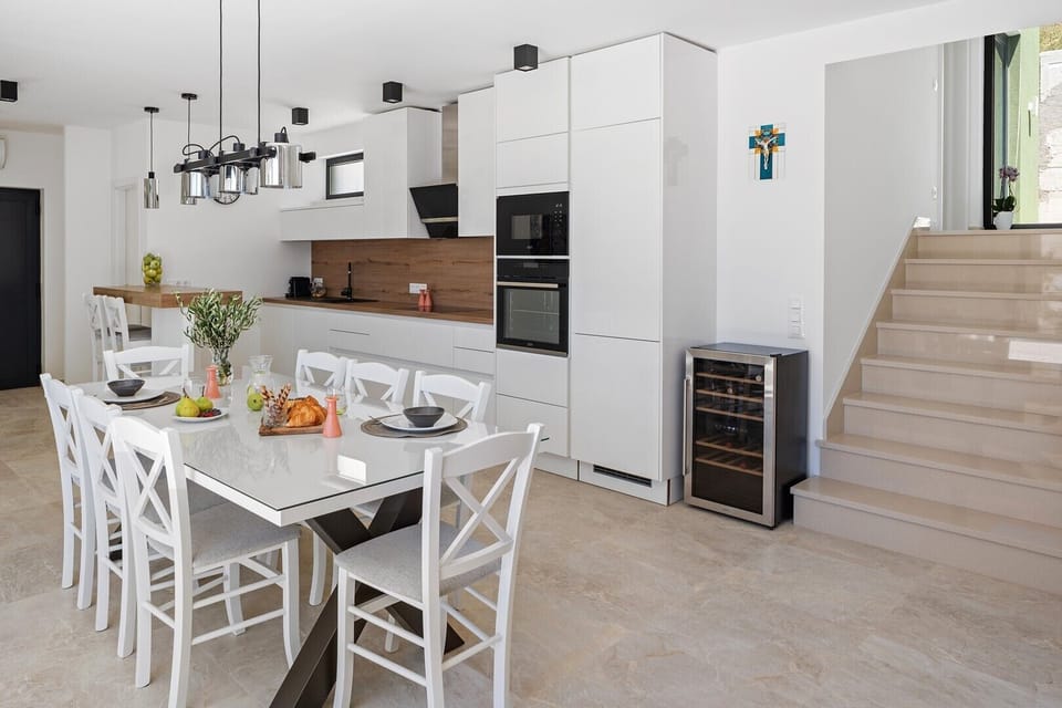 An open-plan living area that includes a stylish and fully equipped kitchen with all the amenities a modern guest
